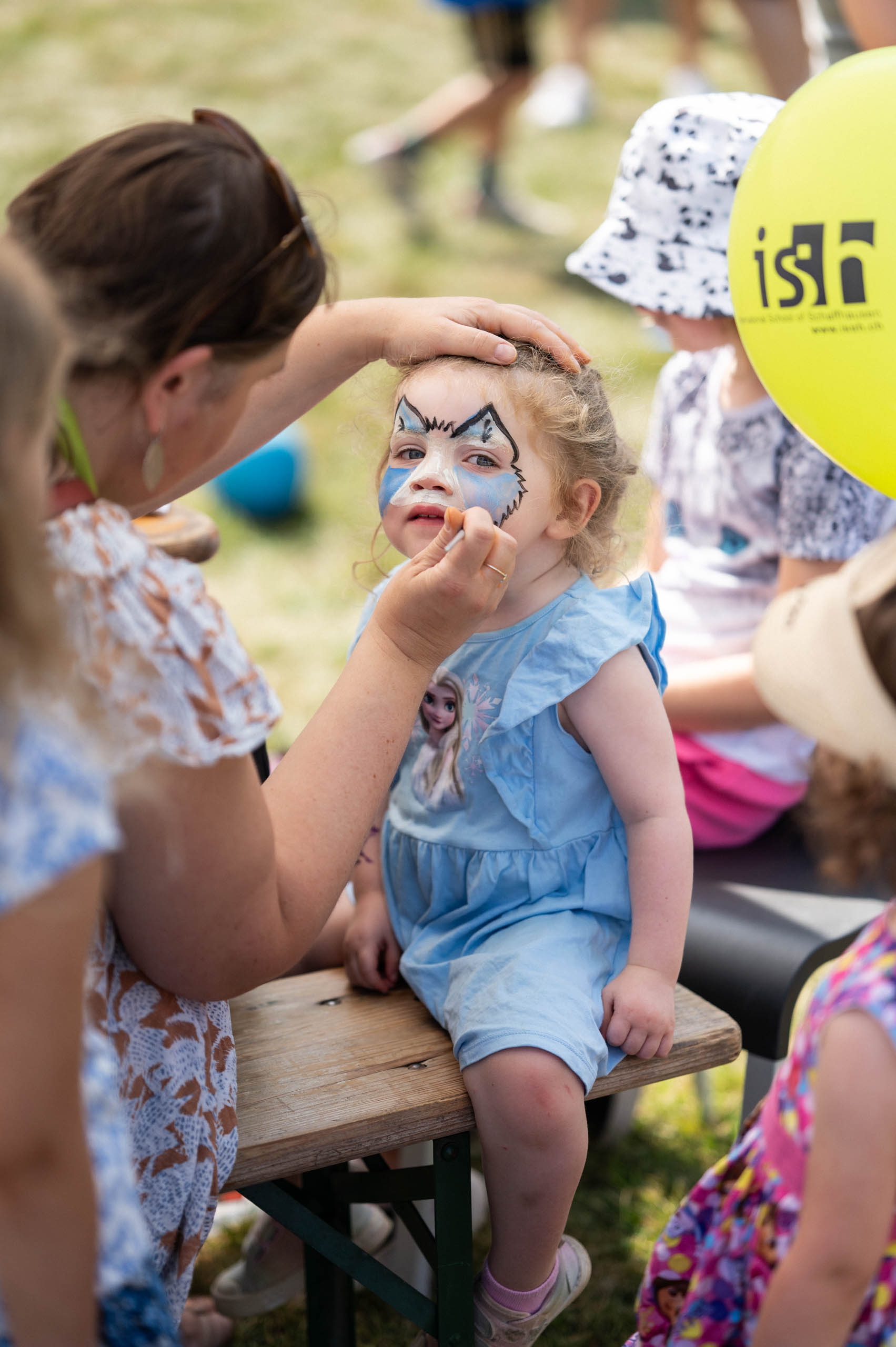 photo of young child with face paint at an ISSH community event
